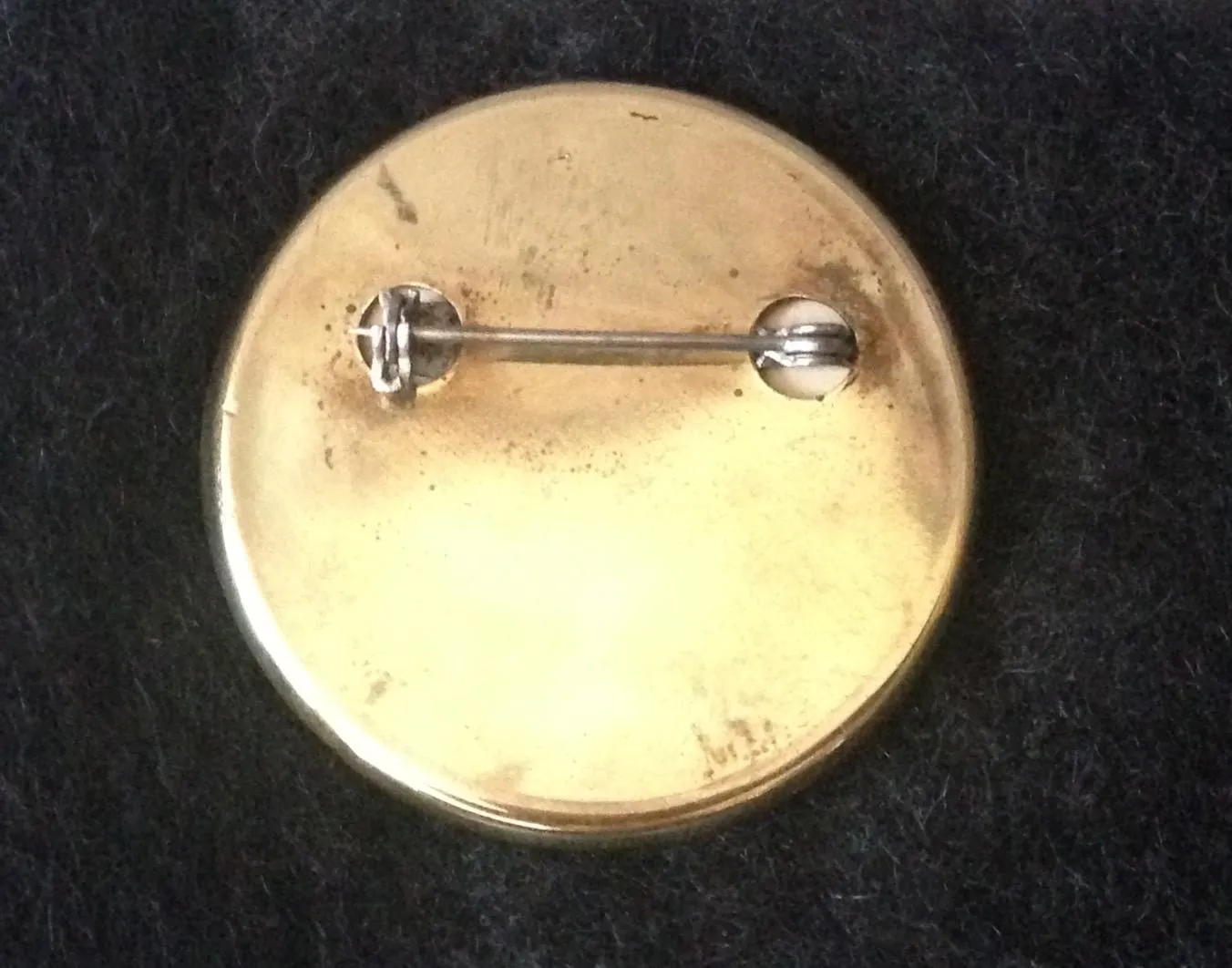 Pin Brass Rosette Featuring a Side Saddle Rider Taking a Hedge